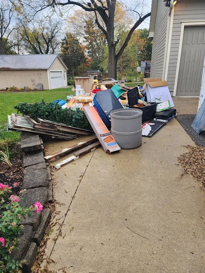 Dumpster being loaded with debris for Roofing Dumpster Rental in Royal Oak